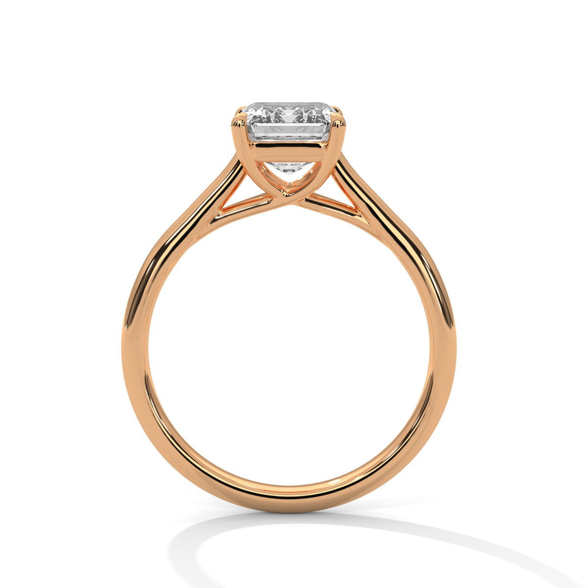 Side profile of an emerald cut diamond solitaire engagement ring in rose gold with a raised four-prong setting and open gallery.