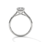 Side profile of an emerald cut diamond solitaire engagement ring in white gold with a raised four-prong setting and open gallery.