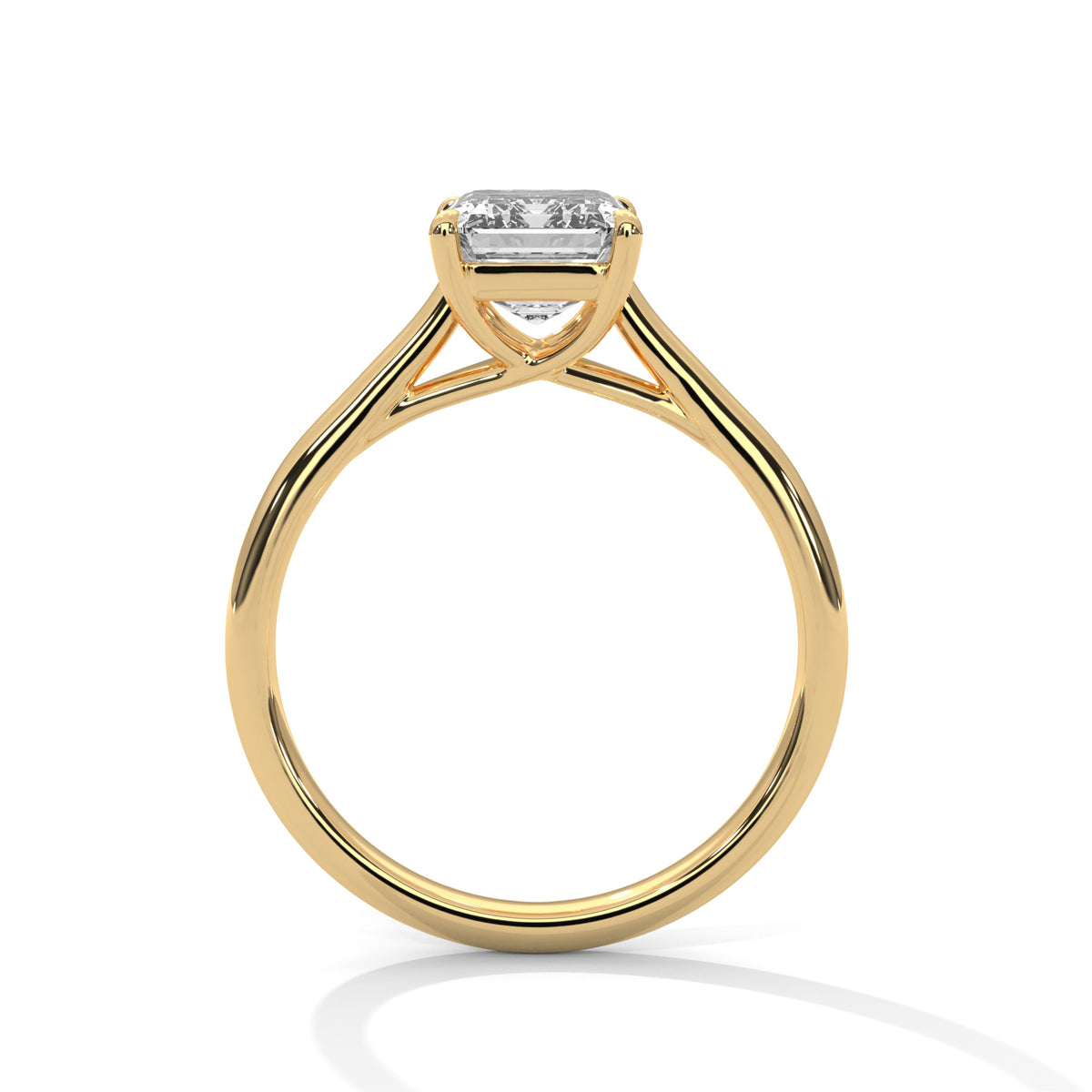 Side profile of an emerald cut diamond solitaire engagement ring in yellow gold with a raised four-prong setting and open gallery.