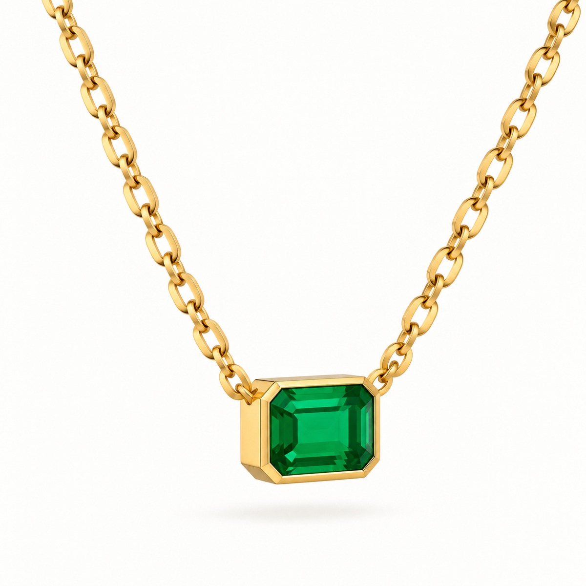 Emerald cut green gemstone pendant necklace in yellow gold with a bezel setting