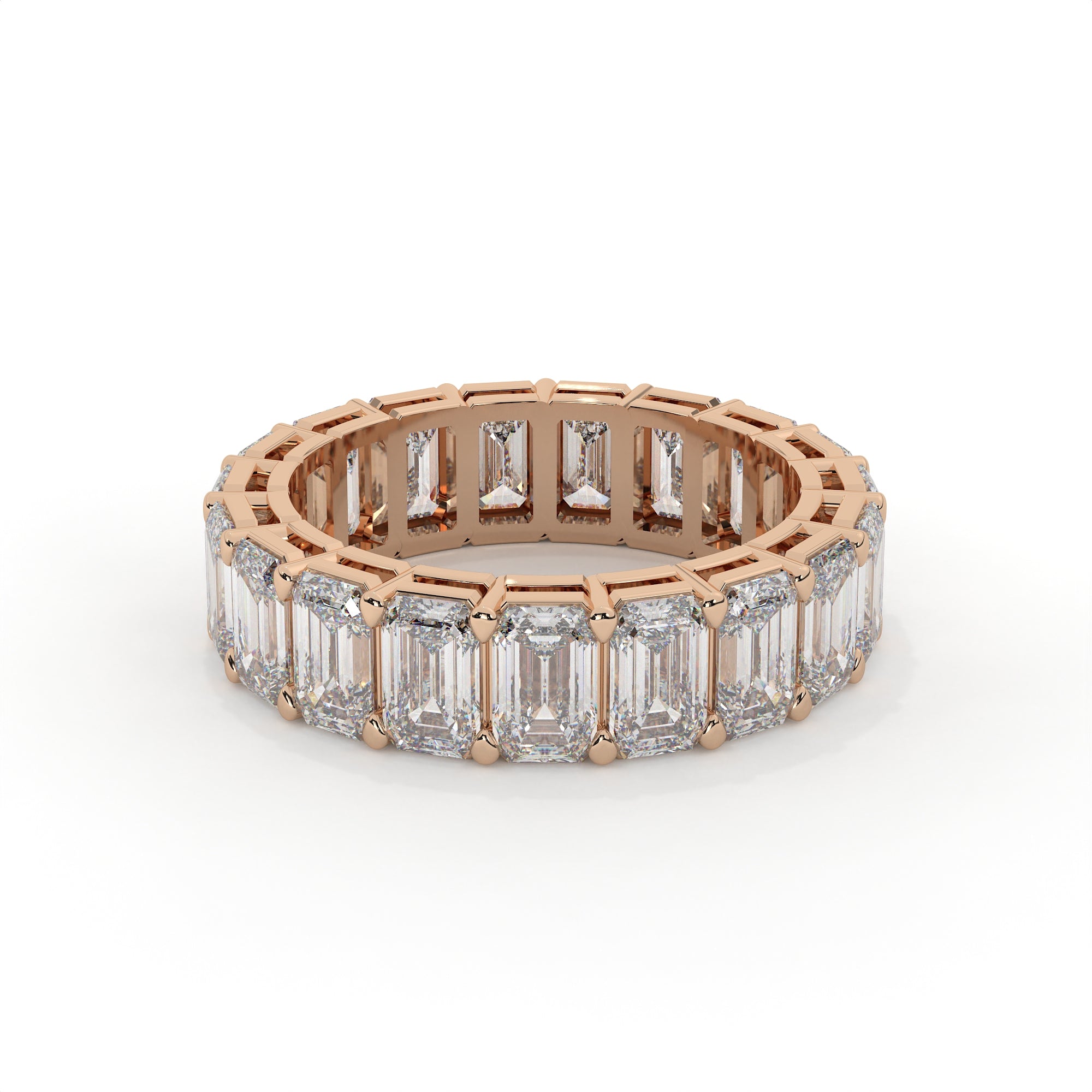 Rose gold ring with emerald-cut diamonds on a white background