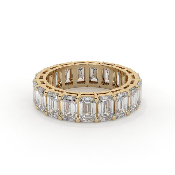 Emerald cut diamond eternity ring featuring a prong setting on a plain background.
