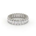 Diamond ring with emerald-cut stones on a white background