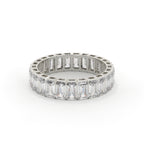 Diamond ring with emerald-cut stones on a white background