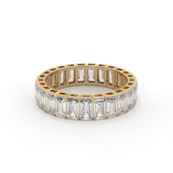 Gold ring with emerald-cut diamonds on a white background