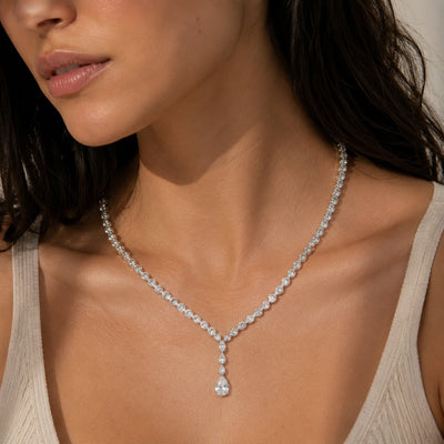 Close-up of a woman wearing a diamond necklace