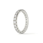Silver ring with embedded diamonds on a white background