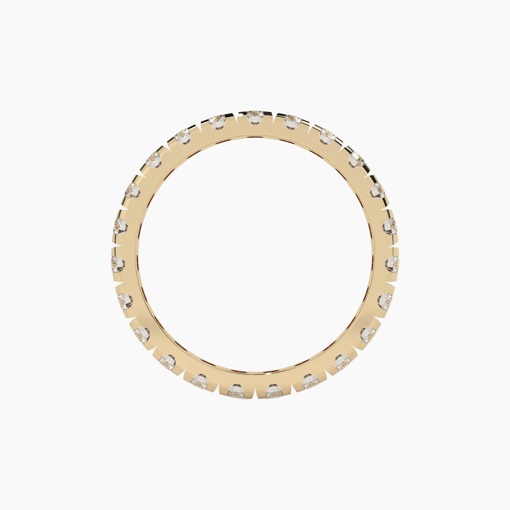 Gold ring with small diamonds on a white background