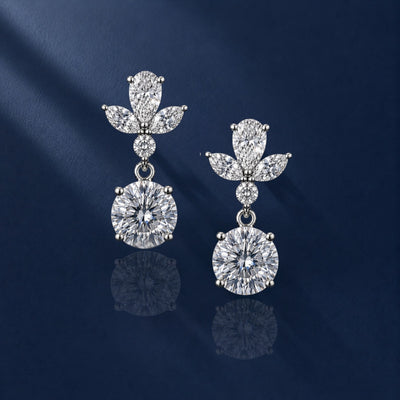 Diamond earrings on a dark blue fabric background