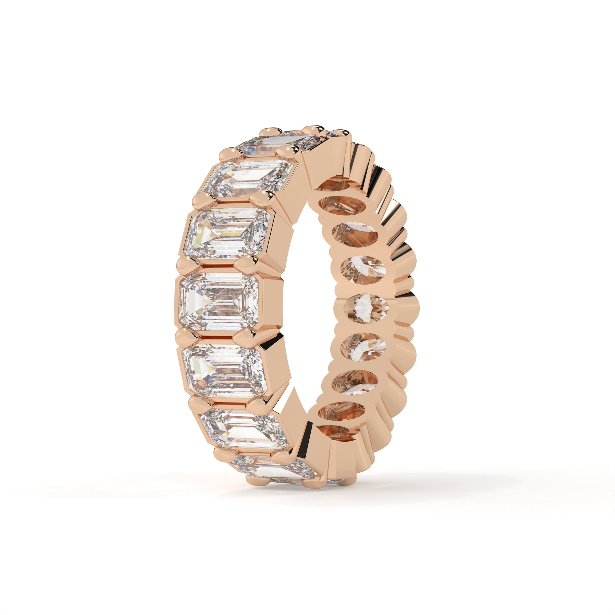 Rose gold ring with emerald-cut diamonds on a white background