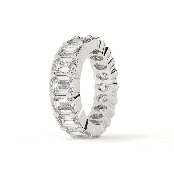 Silver ring with emerald-cut and round diamonds on a white background