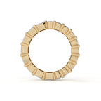 Gold ring with a central gemstone on a white background