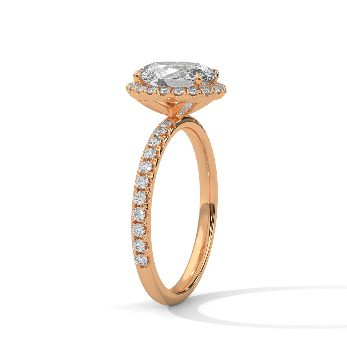 Angled side view of an oval cut diamond halo engagement ring in rose gold with a pavé diamond band and raised halo setting.