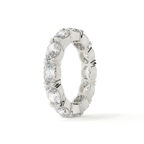 Silver ring with embedded diamonds on a white background
