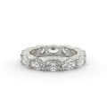 Silver ring with multiple diamonds on a white background