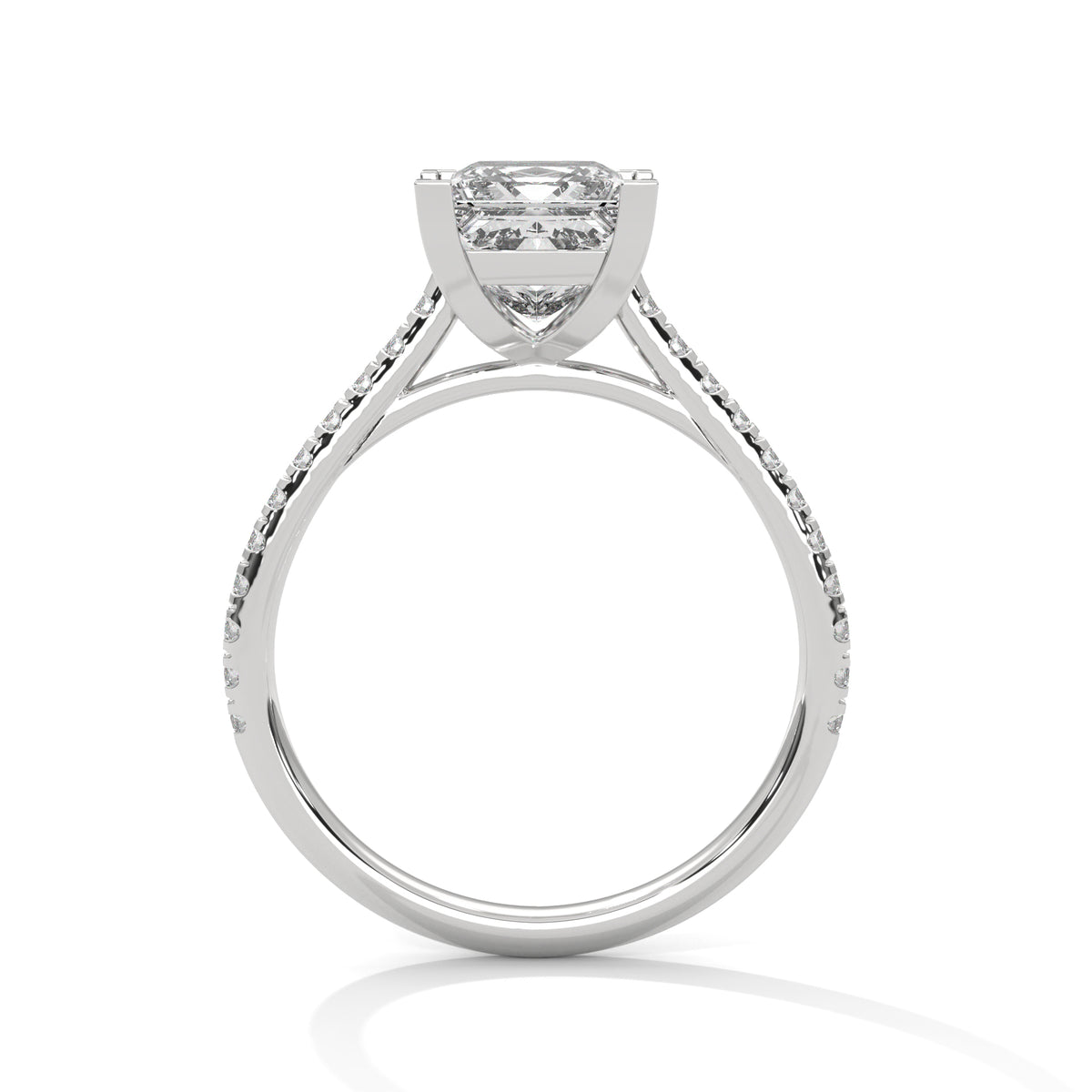 Side profile of a princess cut diamond engagement ring in white gold with a pavé diamond band, raised four-prong setting, and open gallery.
