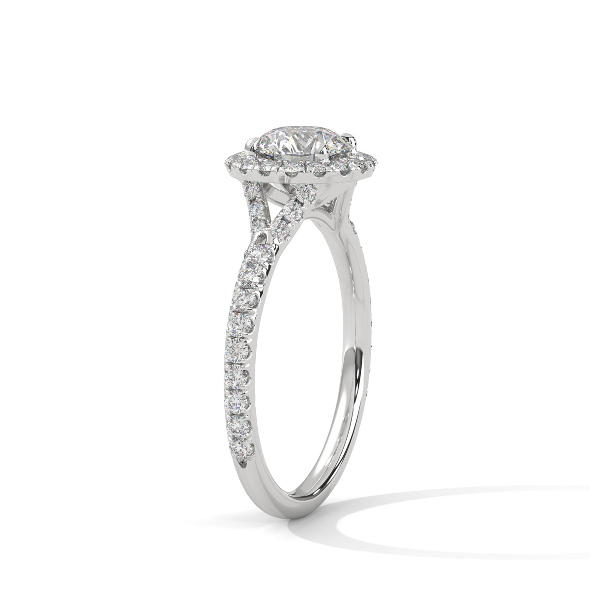 Angled side view of a round cut diamond halo engagement ring in white gold with a pavé diamond band and diamond-accented gallery.