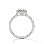 Side profile of a round cut diamond halo engagement ring in white gold with a pave diamond band and raised gallery setting.