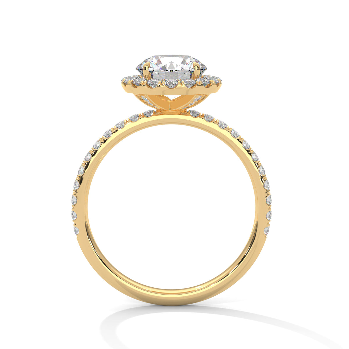 Side profile of a round cut diamond halo engagement ring in yellow gold with a pavé diamond band and raised halo setting.