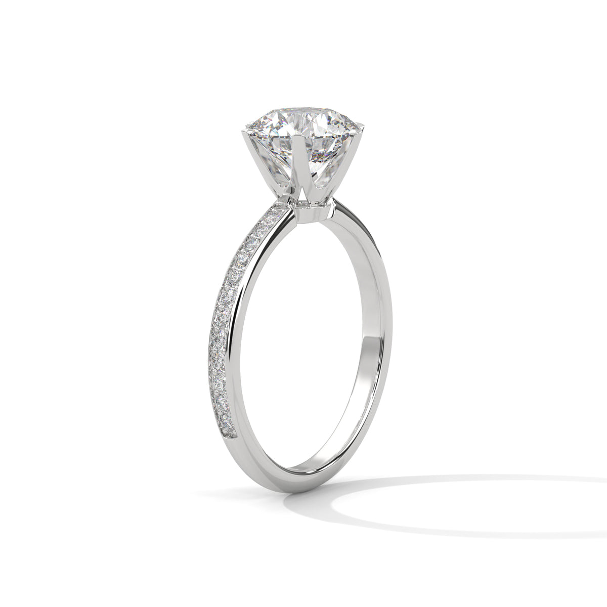 Side angle of a round cut diamond engagement ring in yellow gold with a raised prong setting and pave diamond band.