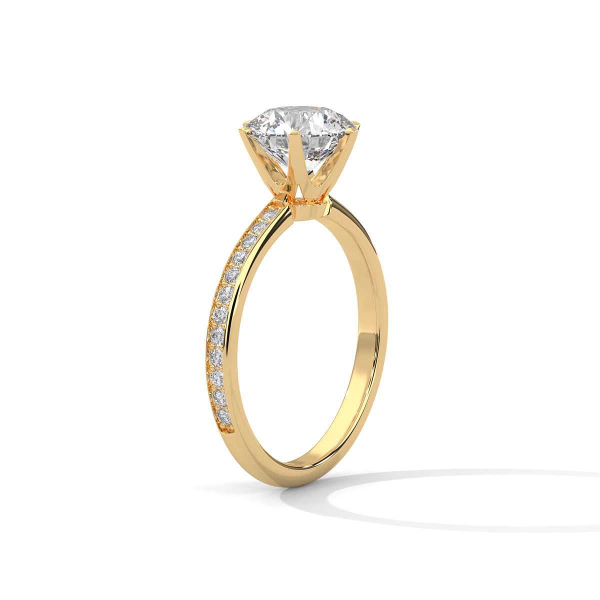 Side angle of a round cut diamond engagement ring in yellow gold with a raised prong setting and pave diamond band.