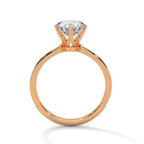Side view of a round cut diamond pave engagement ring in rose gold with a raised prong setting on a white background.