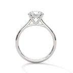 Side profile of a round cut diamond solitaire engagement ring in white gold with a raised four-prong setting and open gallery.
