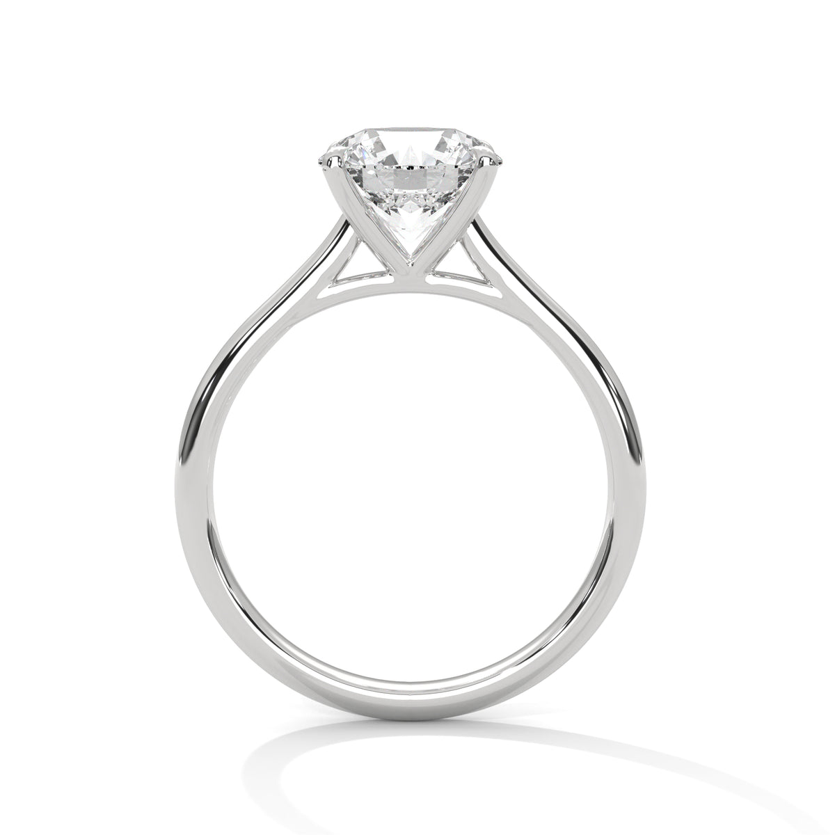 Side profile of a round cut diamond solitaire engagement ring in white gold with a raised four-prong setting and open gallery.