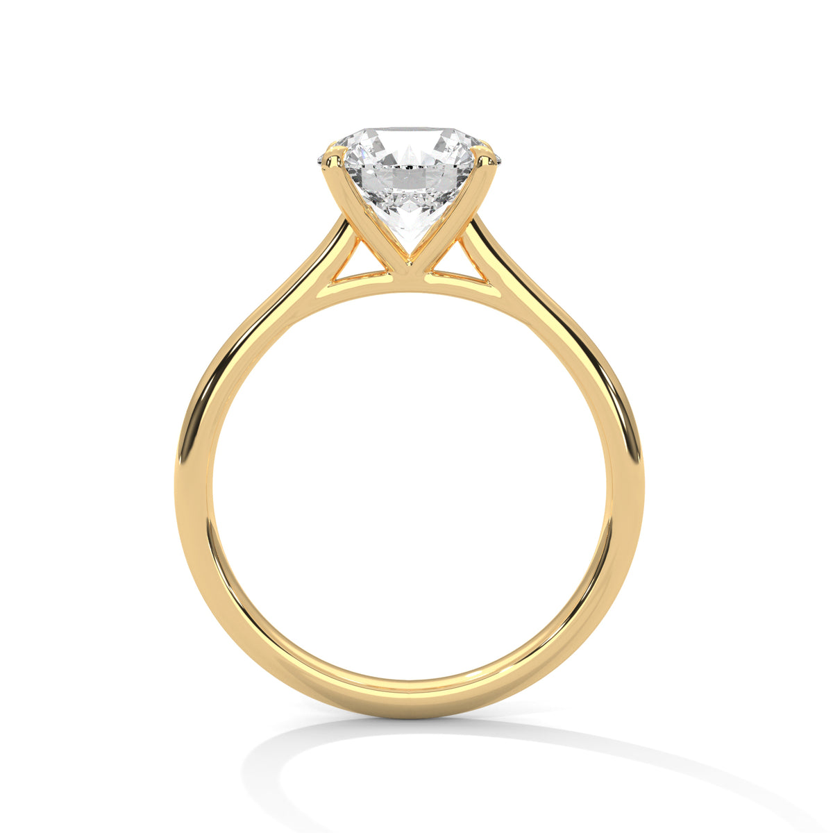 Side profile of a round cut diamond solitaire engagement ring in yellow gold with a raised four-prong setting and open gallery.