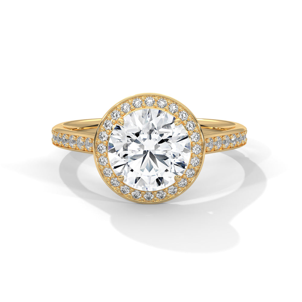 Round cut diamond halo engagement ring in yellow gold with a pave diamond band, shown in a front product view.