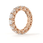 Rose gold ring with diamond accents on a white background
