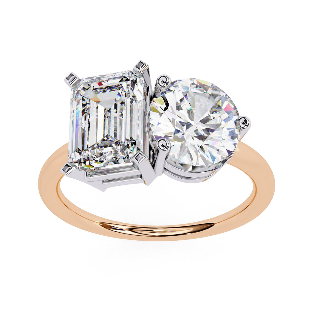 Two-stone diamond ring with emerald-cut and round-cut diamonds on a white background
