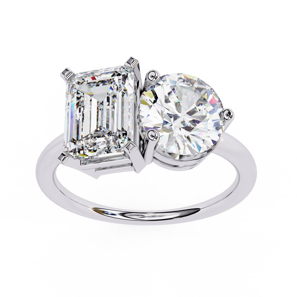 Diamond ring with two prominent gemstones on a white background